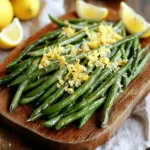 Für dieses einfache Rezept brauchst du diese Hauptzutaten: - 450 g frische grüne Bohnen, geputzt - 2 Esslöffel Olivenöl - 1 Teelöffel Knoblauchpulver - 1 Teelöffel Zwiebelpulver - 1/2 Teelöffel schwarzer Pfeffer - 1/4 Teelöffel Meersalz - 125 g geriebener Parmesan-Käse Die grünen Bohnen sind die Hauptzutat. Du möchtest frische Bohnen verwenden, damit sie knackig bleiben. Wenn du gefrorene Bohnen nimmst, achte darauf, sie gut abzutropfen. Das Olivenöl hilft, die Gewürze an den Bohnen zu haften und macht sie schön goldbraun. Die Gewürze sind wichtig für den Geschmack. Ich benutze: - 1 Teelöffel Knoblauchpulver - 1 Teelöffel Zwiebelpulver - 1/2 Teelöffel schwarzer Pfeffer - 1/4 Teelöffel Meersalz - 1/4 Teelöffel zerdrückte rote Paprikaflocken (optional) Knoblauchpulver gibt Aroma und Tiefe. Zwiebelpulver fügt einen süßen Geschmack hinzu. Der schwarze Pfeffer bringt ein wenig Schärfe. Das Meersalz hebt alle Aromen hervor. Die Paprikaflocken sind optional, geben aber einen schönen Kick. Du kannst das Rezept anpassen. Hier sind einige Optionen: - Abrieb von 1 Zitrone - Frische Zitronenschnitze zum Servieren Der Zitronenabrieb bringt Frische. Es passt gut zu den Bohnen und dem Käse. Wenn du eine andere Käsesorte ausprobieren möchtest, kannst du auch Pecorino nehmen. Das Rezept ist flexibel. Du kannst die Gewürze nach deinem Geschmack ändern. Willst du mehr Würze? Füge etwas Chili-Pulver hinzu! Für das komplette Rezept, siehe die Anleitung [Full Recipe]. Heizen Sie Ihren Ofen auf 220°C vor. Legen Sie ein Backblech mit Backpapier aus. Das Backpapier hilft bei der Reinigung. Nehmen Sie 450 g frische grüne Bohnen und putzen Sie sie gut. Geben Sie die Bohnen in eine große Schüssel. Fügen Sie 2 Esslöffel Olivenöl hinzu. Dann kommen 1 Teelöffel Knoblauchpulver und 1 Teelöffel Zwiebelpulver dazu. Streuen Sie 1/2 Teelöffel schwarzen Pfeffer und 1/4 Teelöffel Meersalz über die Bohnen. Wenn Sie möchten, können Sie auch 1/4 Teelöffel zerdrückte rote Paprikaflocken hinzufügen. Vermischen Sie alles gut, bis die Bohnen gleichmäßig bedeckt sind. Verteilen Sie die marinierten Bohnen auf dem Backblech. Achten Sie darauf, dass sie in einer einzigen Schicht liegen. Rösten Sie die Bohnen für 15 Minuten im Ofen. Schütteln Sie das Blech nach 7-8 Minuten. So garen die Bohnen gleichmäßig. Nach 15 Minuten nehmen Sie das Blech heraus. Bestreuen Sie die Bohnen mit 125 g geriebenem Parmesan-Käse. Schieben Sie das Blech zurück in den Ofen. Rösten Sie die Bohnen für weitere 5-7 Minuten, bis der Käse knusprig ist. Nehmen Sie das Blech heraus und streuen Sie den Abrieb von 1 Zitrone darüber. Servieren Sie die Bohnen warm mit frischen Zitronenschnitzen. Für mehr Details schauen Sie sich das Full Recipe an. Um die perfekte Konsistenz für geröstete Parmesan-Grüne Bohnen zu erreichen, ist die Ofentemperatur wichtig. Ich empfehle, den Ofen auf 220°C vorzuheizen. Die Bohnen brauchen Hitze, um knusprig zu werden. Rösten Sie sie nicht zu lange, damit sie zart bleiben. Die richtige Balance ist entscheidend. Frische grüne Bohnen bieten oft besseren Geschmack und Textur. Sie sind knackiger und haben mehr Aroma. Wenn Sie gefrorene Bohnen verwenden, tauten Sie diese zuerst auf. Achten Sie darauf, sie gut abzutrocknen, um überschüssige Feuchtigkeit zu vermeiden. Dies hilft, die Bohnen beim Rösten knusprig zu halten. Bewahren Sie die Reste in einem luftdichten Behälter im Kühlschrank auf. So bleiben sie frisch für bis zu drei Tage. Zum Aufwärmen geben Sie die Bohnen auf ein Backblech und rösten sie kurz bei 180°C. So werden sie wieder knusprig. Alternativ können Sie sie in der Mikrowelle aufwärmen, aber die Konsistenz wird nicht so gut sein. Für das vollständige Rezept, schauen Sie sich bitte die Anleitung zu den gerösteten Parmesan-Grünen Bohnen an. {{image_4}} Um Ihre gerösteten Parmesan-Grünen Bohnen noch schmackhafter zu machen, können Sie einige zusätzliche Zutaten hinzufügen. Überlegen Sie, etwas Zitronensaft hinzuzufügen, um die Bohnen frisch zu halten. Auch geröstete Mandeln oder Pinienkerne geben einen schönen Crunch. Für einen asiatischen Twist können Sie einige Sesamsamen hinzufügen. Diese kleinen Ergänzungen bringen viel Geschmack und Textur in das Gericht. Wenn Sie keinen Parmesan mögen oder eine andere Wahl treffen möchten, gibt es viele Alternativen. Pecorino-Käse hat einen ähnlichen Geschmack, ist aber salziger. Feta-Käse kann eine weitere interessante Option sein, die etwas krümeliger ist. Für einen milderen Geschmack probieren Sie Mozzarella. Jede dieser Alternativen bringt ihre eigene Note in das Gericht. Für eine vegane Version der gerösteten Bohnen können Sie anstelle von Parmesan einen veganen Käse verwenden. Es gibt viele leckere, pflanzliche Käsesorten, die gut schmelzen. Auch nutritional yeast ist eine tolle Option. Es hat einen käsigen Geschmack und ist reich an Vitaminen. Denken Sie daran, das Olivenöl durch ein anderes pflanzliches Öl zu ersetzen, falls nötig. So bleibt das Gericht lecker und dennoch vegan. Für das vollständige Rezept schauen Sie sich die Details zum Kochen an. Um die besten Ergebnisse zu erzielen, lagere die Reste in einem luftdichten Behälter. Stelle sicher, dass die Bohnen vollständig abgekühlt sind, bevor du sie in den Kühlschrank stellst. So bleibt die Textur besser erhalten. Du kannst auch ein Stück Küchenpapier in den Behälter legen. Das hilft, Feuchtigkeit zu absorbieren. Die gerösteten grünen Bohnen halten sich im Kühlschrank etwa 3 bis 4 Tage. Achte darauf, sie rechtzeitig zu genießen, um den besten Geschmack zu erleben. Wenn du sie länger aufbewahren möchtest, ist das Einfrieren eine gute Option. Um geröstete grüne Bohnen einzufrieren, lasse sie vorher vollständig abkühlen. Lege sie in einen gefrierfesten Beutel und drücke die Luft heraus. So bleiben sie frisch und schmackhaft. Sie können bis zu 3 Monate eingefroren werden. Zum Auftauen lege die Bohnen einfach in den Kühlschrank über Nacht. Zum Aufwärmen kannst du sie in einer Pfanne oder im Ofen rösten, um die Knusprigkeit zurückzugewinnen. Geröstete grüne Bohnen bleiben im Kühlschrank etwa drei bis fünf Tage frisch. Bewahren Sie sie in einem luftdichten Behälter auf. So bleiben sie länger knackig und schmackhaft. Achten Sie darauf, dass sie gut abgekühlt sind, bevor Sie sie lagern. Auf diese Weise verhindern Sie, dass sich Feuchtigkeit bildet. Wenn Sie sie länger aufbewahren möchten, können Sie sie auch einfrieren. Ja, das Rezept ist sehr anpassbar! Sie können verschiedene Gewürze verwenden, um den Geschmack zu verändern. Zum Beispiel können Sie Paprika, Thymian oder Rosmarin hinzufügen. Auch der Käse ist variierbar. Feta oder Cheddar geben einen anderen Geschmack. Wenn Sie die Bohnen nicht so knusprig mögen, reduzieren Sie die Röstdauer. Seien Sie kreativ und probieren Sie neue Kombinationen aus! Geröstete Parmesan-Grüne Bohnen passen gut zu vielen Gerichten. Sie sind eine tolle Beilage zu gegrilltem Hühnchen oder Lachs. Auch zu Pasta oder einem frischen Salat sind sie lecker. Sie bringen Farbe und Geschmack auf den Teller. Servieren Sie sie zu einem festlichen Abendessen oder einem einfachen Familienessen. Lassen Sie sich von der Vielseitigkeit dieser Beilage inspirieren! Geröstete Parmesan-Grüne Bohnen sind einfach und lecker. Wir haben die Hauptzutaten und ihre Varianten besprochen. Ich habe dir gezeigt, wie du die Bohnen bestens vorbereitest und röstest. Auch Tipps zur Konsistenz und Lagerung waren dabei. Du kannst das Rezept anpassen und nach deinem Geschmack variieren. Denk daran: Die Lagerung ist wichtig für den Genuss. Probiere neue Zutaten aus und finde deinen Favoriten. Lass deiner Kreativität freien Lauf und genieße dein Gericht!